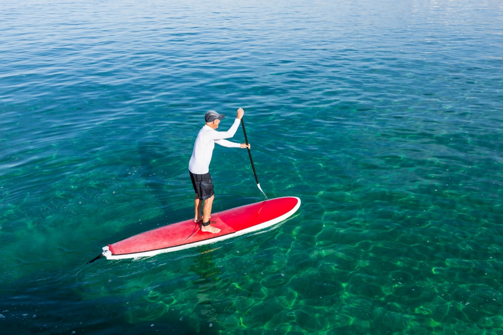 A senior man practicing paddle on a beautiful sunny day