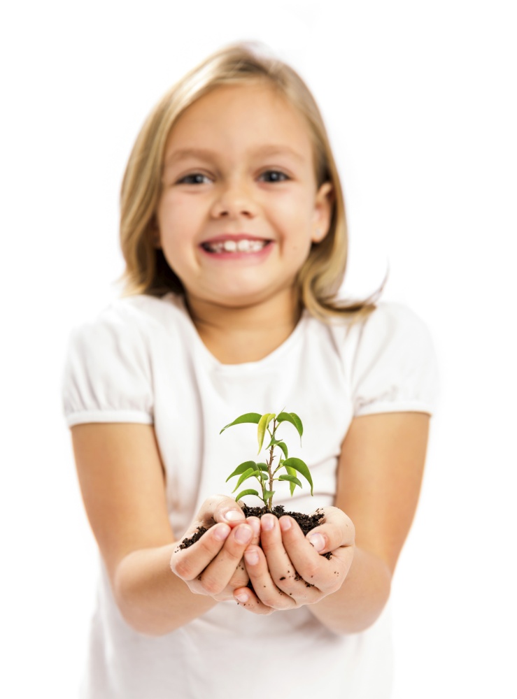 Happy little girl showing a plant on her little hands