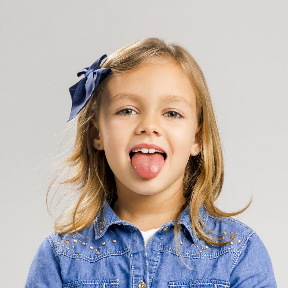 Portrait of a cute little girl with her tongue out