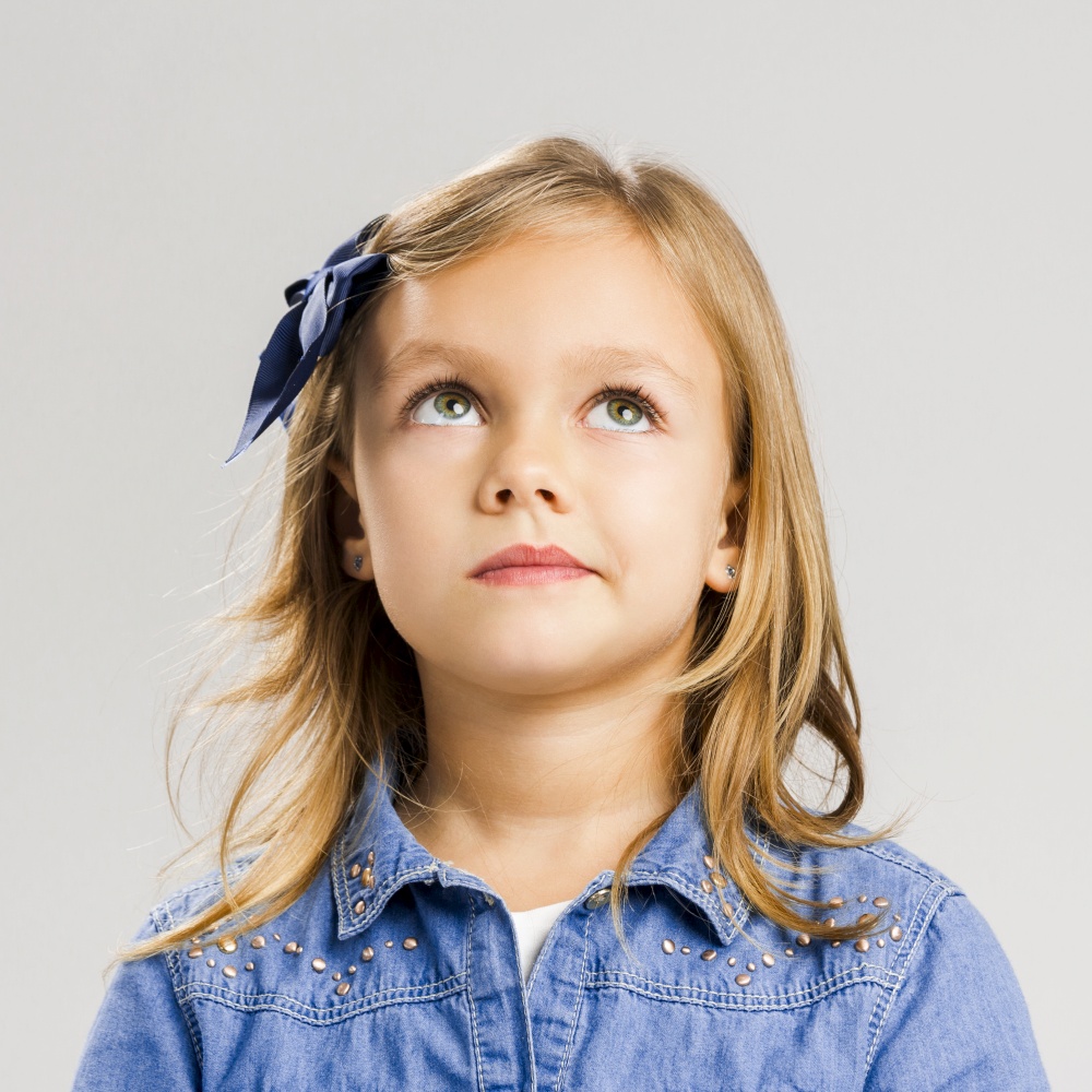 Studio portrait of a little girl thinking