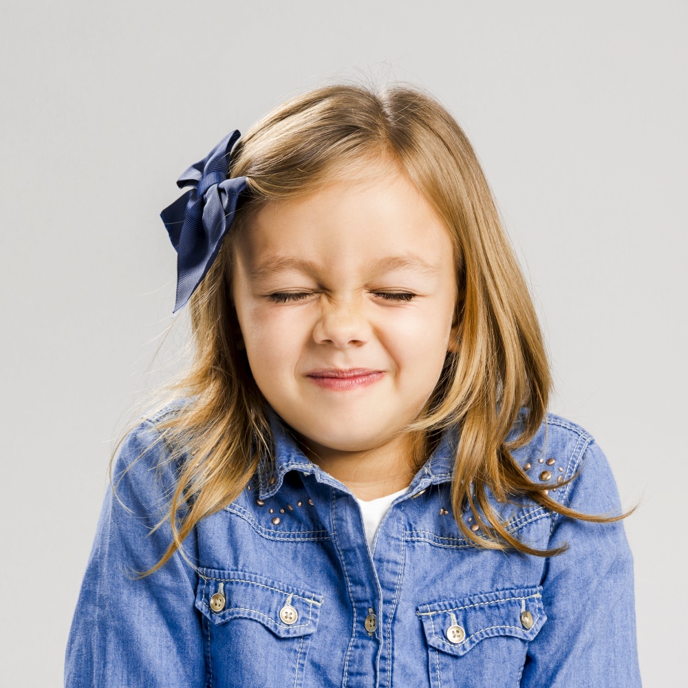Studio portrait of a cute litle girl with eyes closed