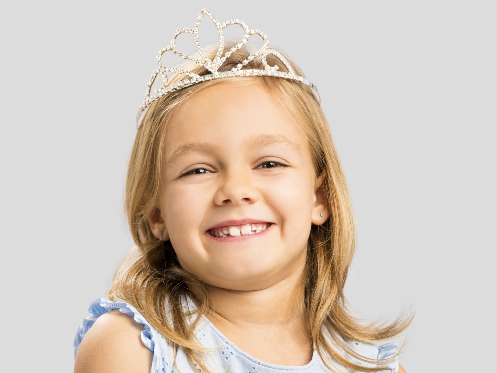 Portrait of a cute happy little girl wearing a princess crown