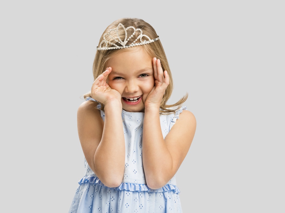 Portrait of a cute happy little girl wearing a princess crown