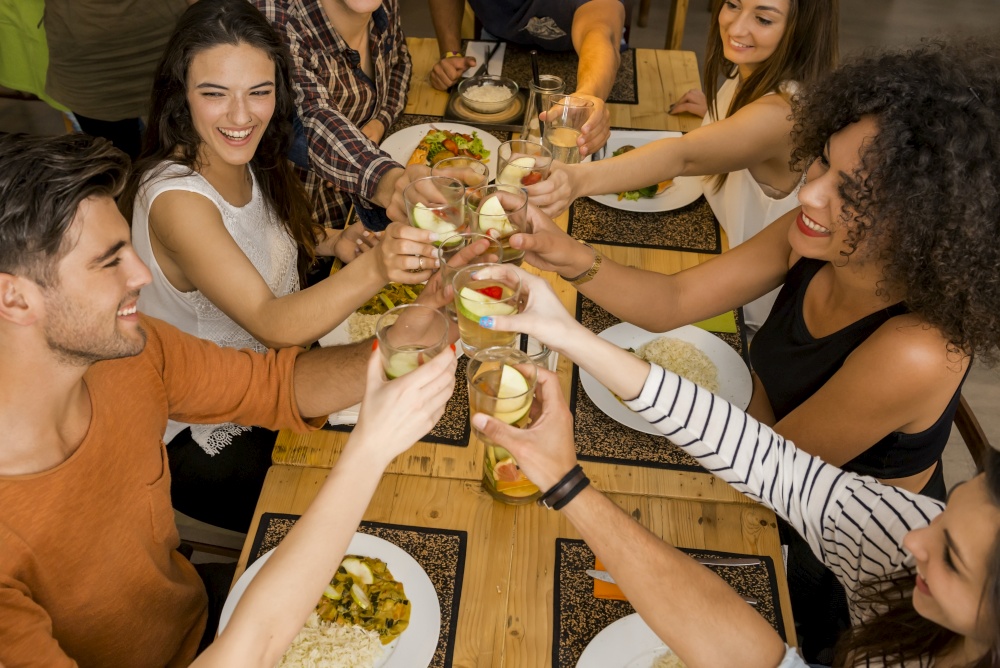 Group of friends toasting and looking happy at a restaurant