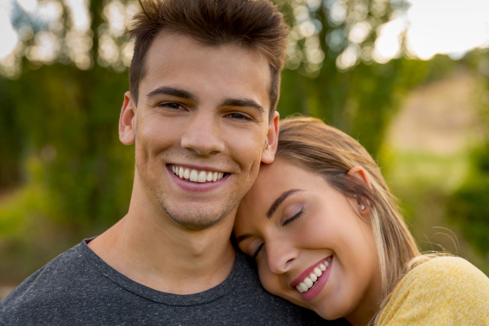 Portrait of a young beautiful couple hugged together