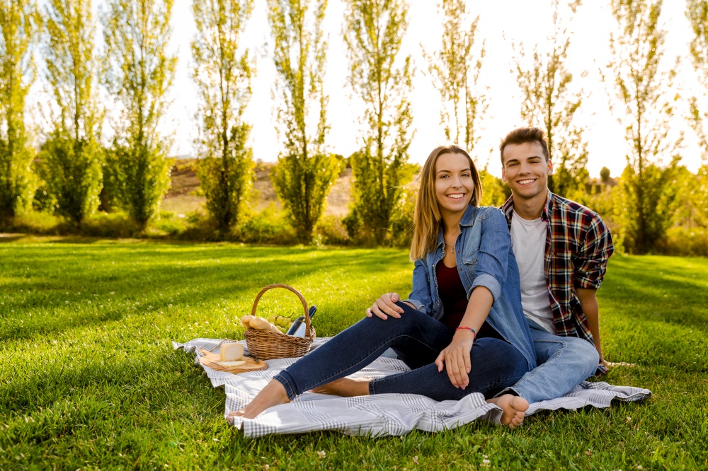 Shot of a beautiful couple on the park making a picnic and having fun