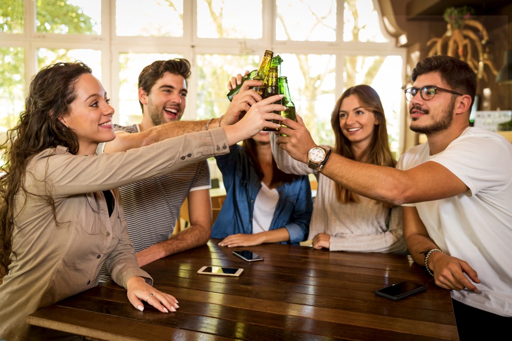 Group of friends hanging out and making a toast with beer