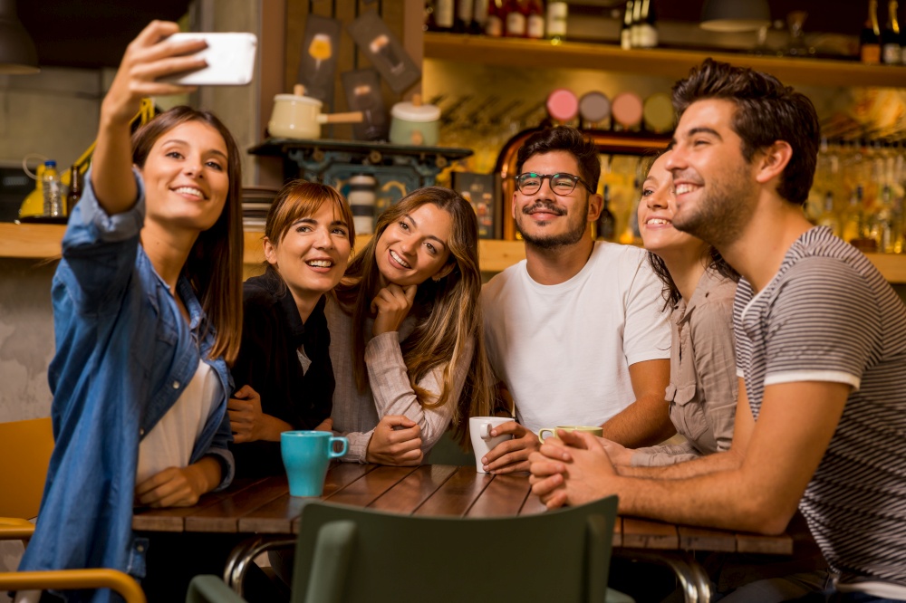 Group of friends taking a selfie at the cafe