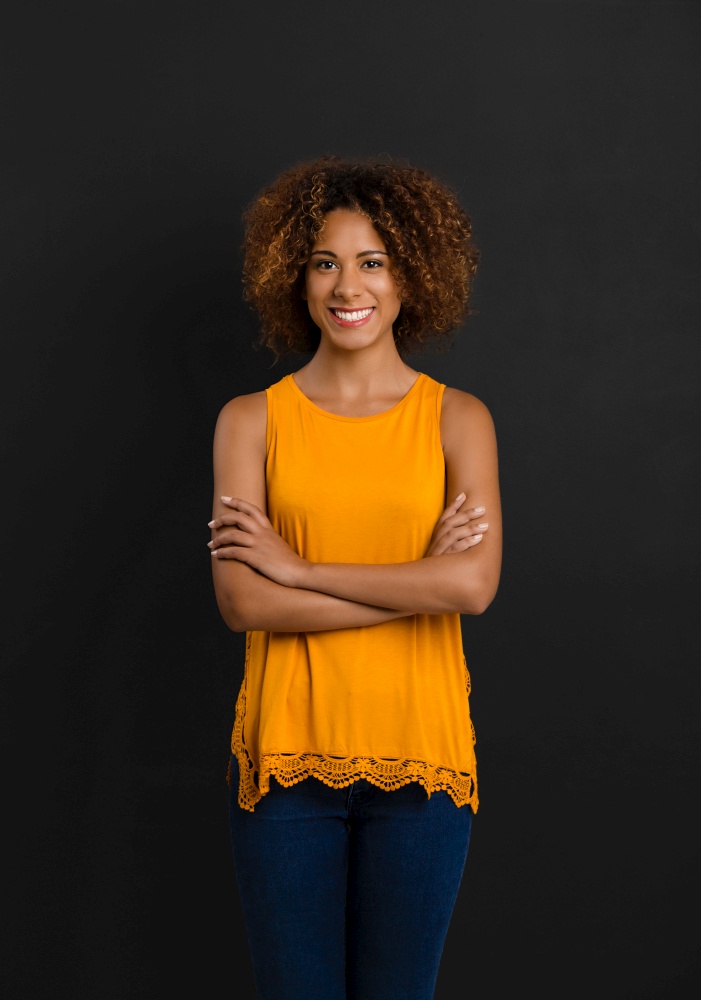 Beautiful African American woman standing with hands folded