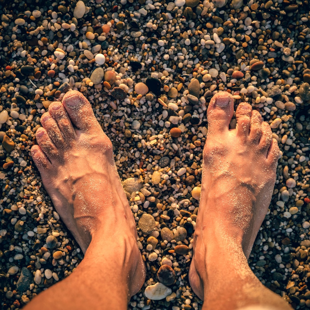Barefoot fellign the sand at the beach