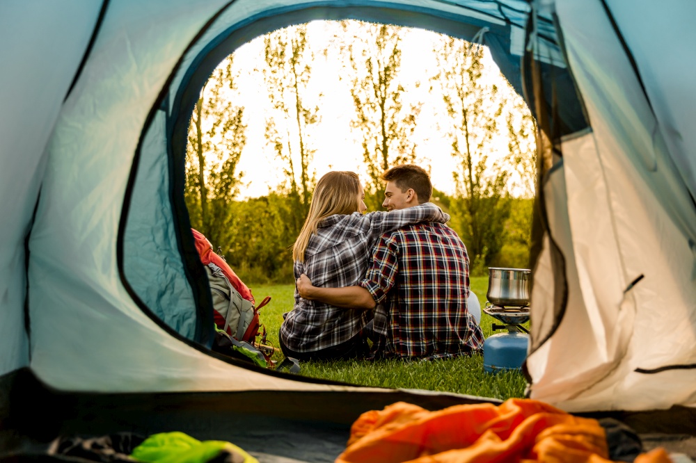 Shot of a happy couple camping on the nature