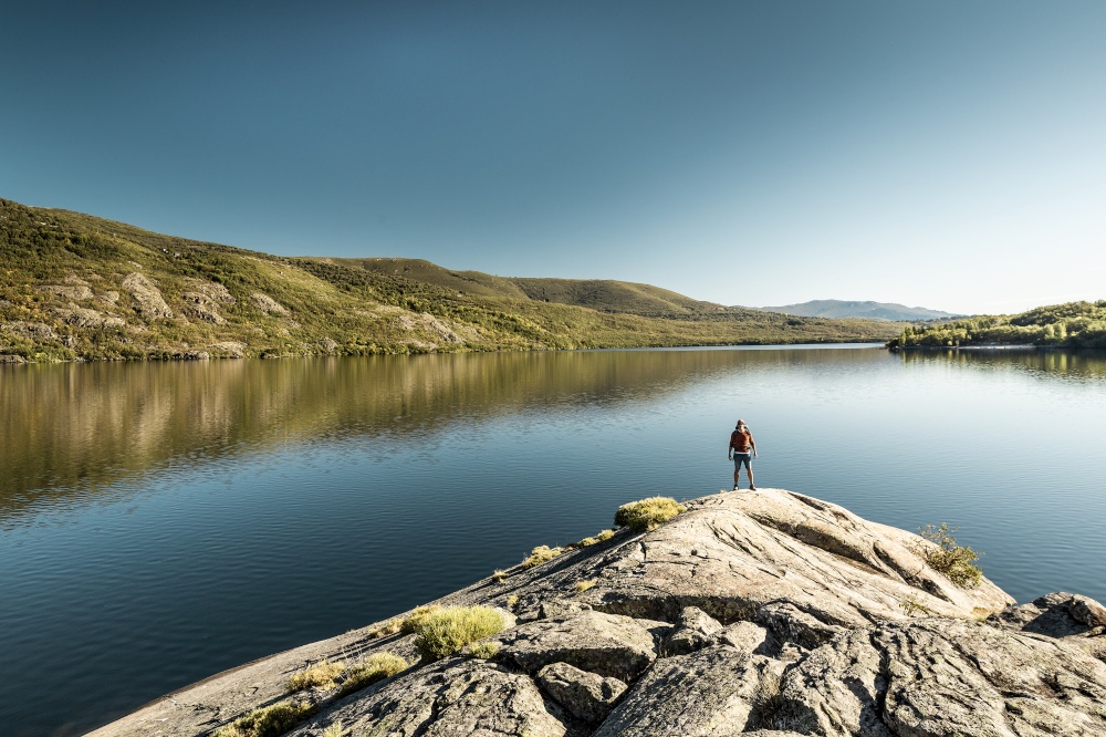 Rear view of a man near a beautiful lake