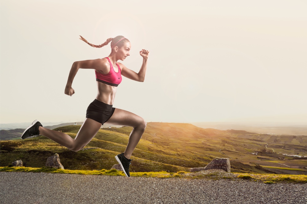 Shot of a sporty young woman runing and jumping