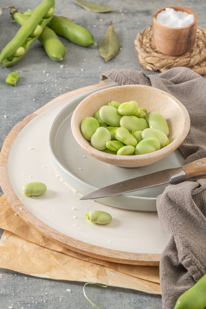 Fresh and raw green broad beans on kitchen table