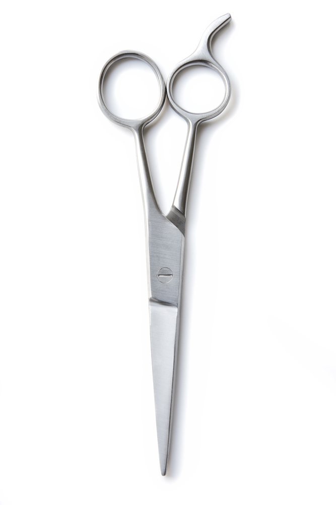 Overhead view of a pair of hairdressers scissors isolated on white background
