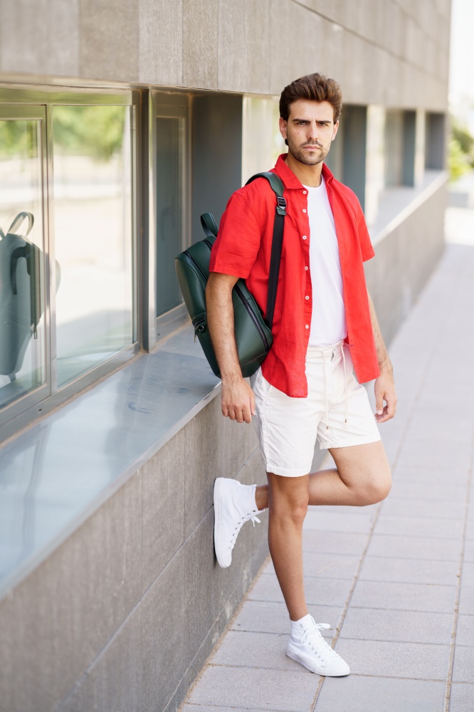 Young fashionable man standing outdoors wearing casual clothes. Fashionable man standing outdoors wearing casual clothes