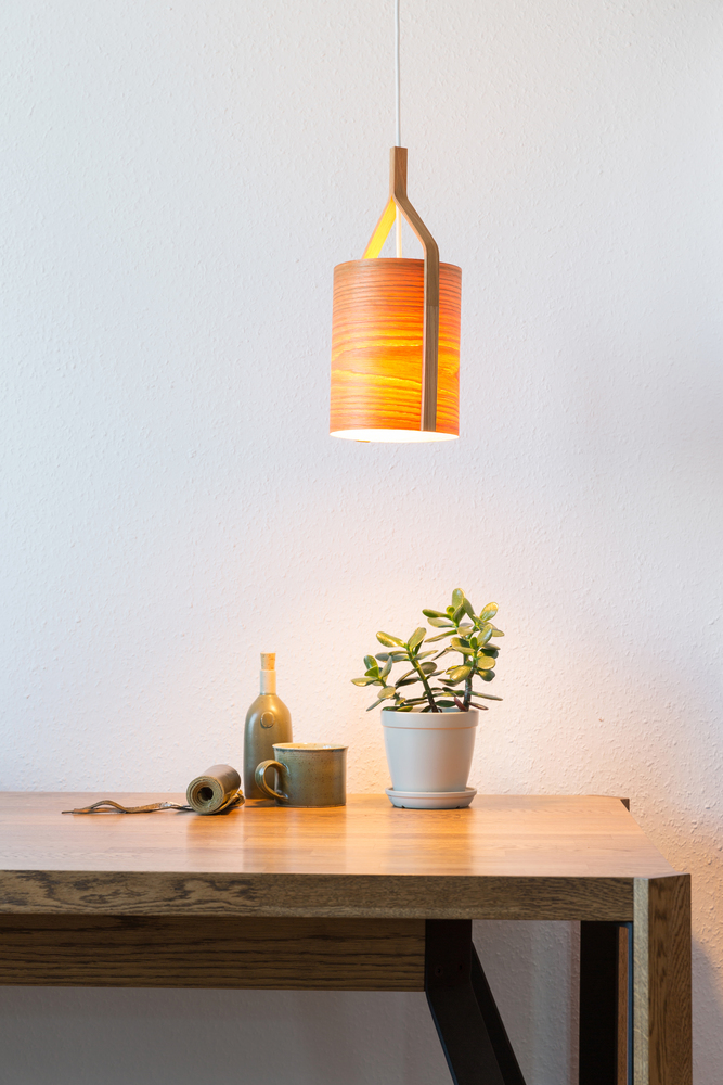 turn on wooden lamp over the table