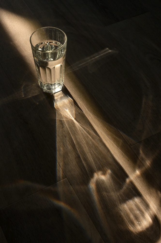 Abstract glass of water and Sunrays