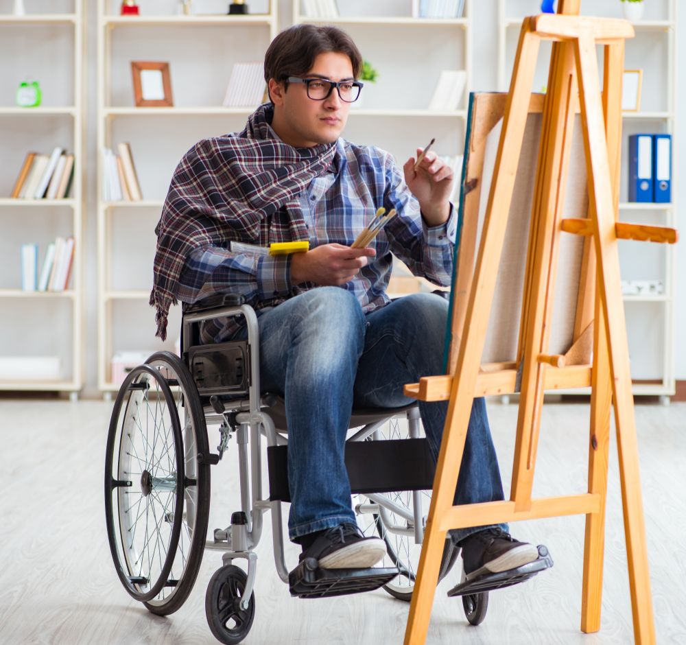The disabled artist painting picture in studio. Disabled artist painting picture in studio