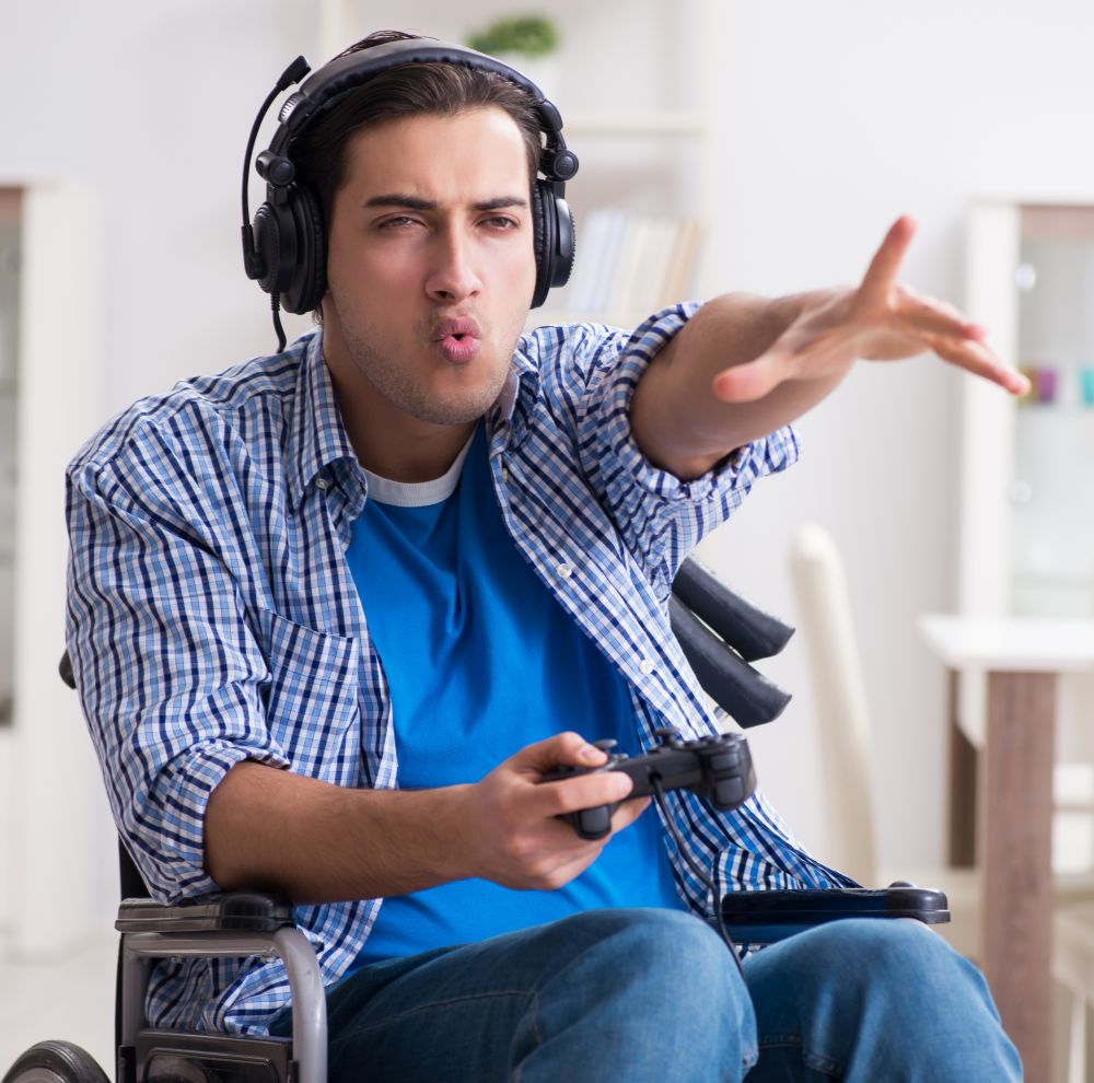 The disabled man playing computer games during rehabilitation. Disabled man playing computer games during rehabilitation