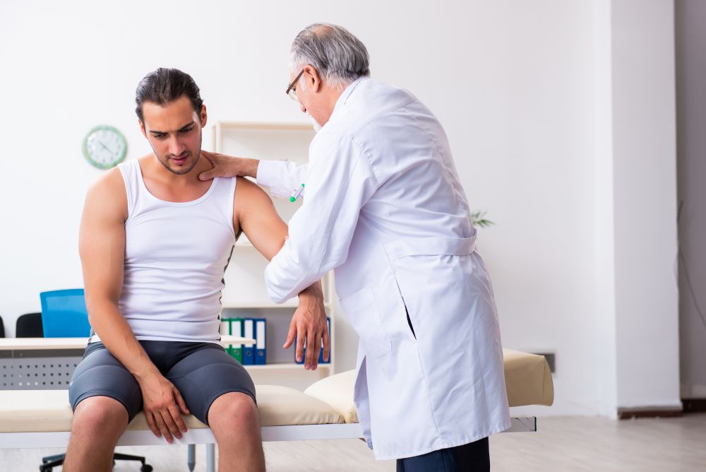 The young male patient visiting experienced doctor. Young male patient visiting experienced doctor