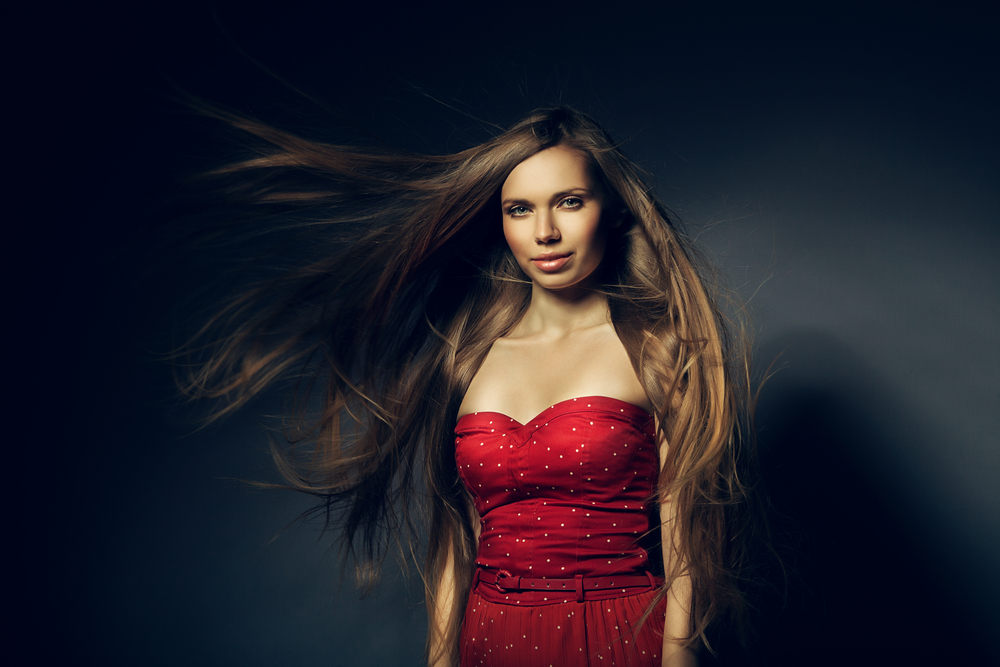 beautiful woman in red with long windy hair