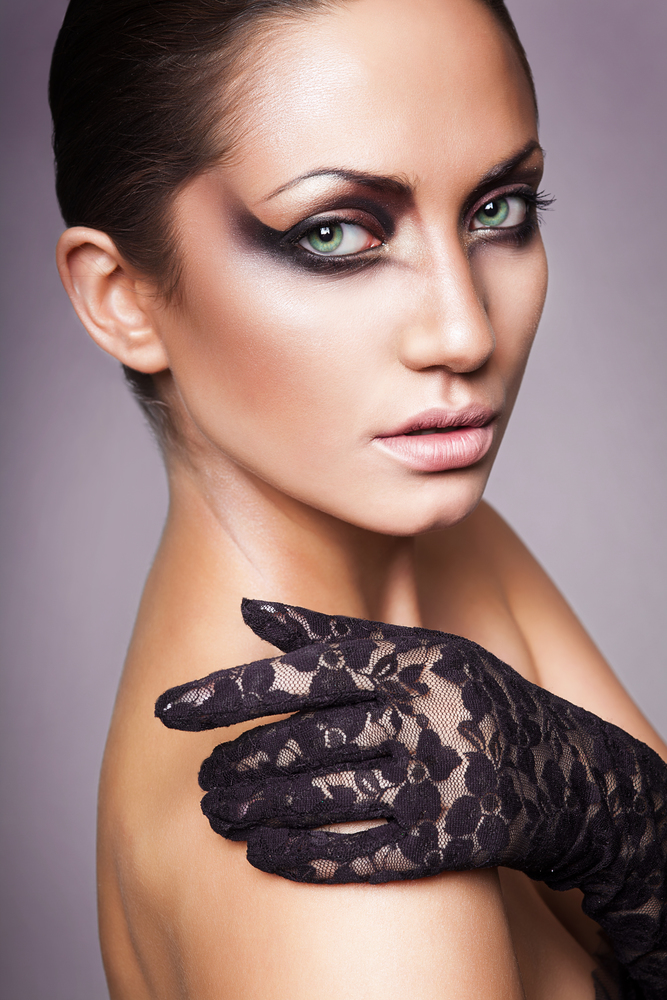 close up portrait of sexy brunette woman with black glove