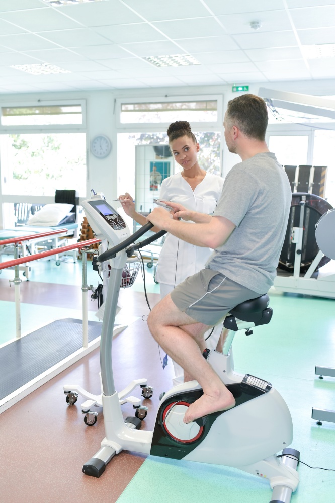 patient having physiotherapy on exercise bike in hospital