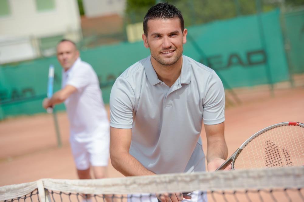 men in the tennis court