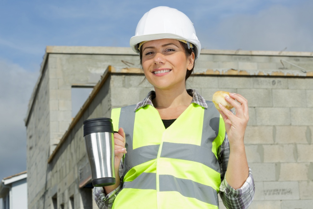 female builder on a break enjoying coffee break