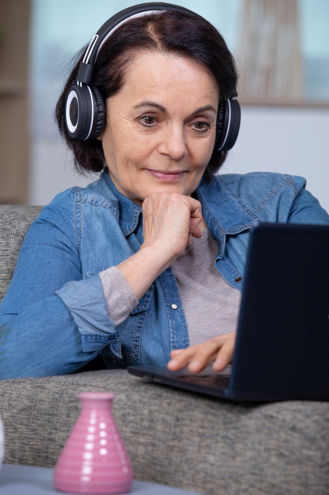 older mature woman using wireless laptop