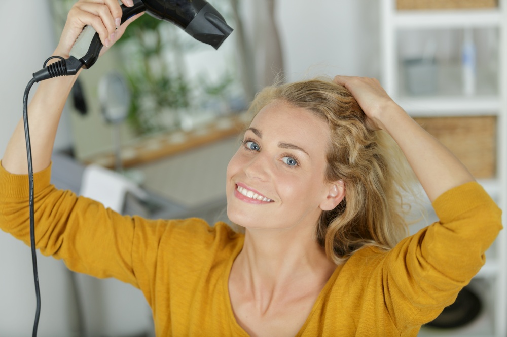 close up of woman with hair dryer