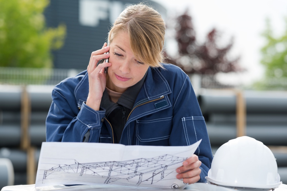 woman on the phone checks the plans outdoors