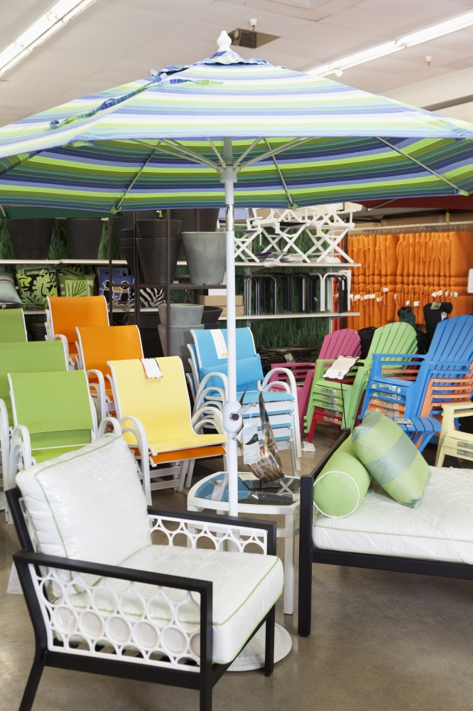 Seating furniture and patio umbrella for sale in garden furniture store
