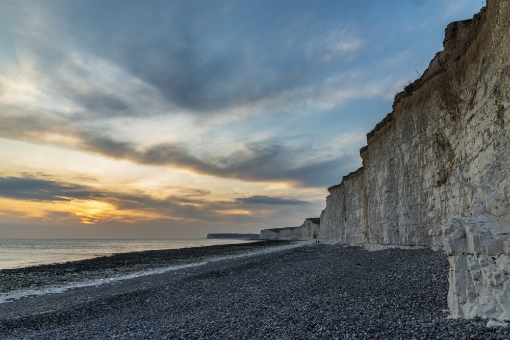 Beautiful landscape image of white chalk cliffs with colorful vibrant sunset on English coast