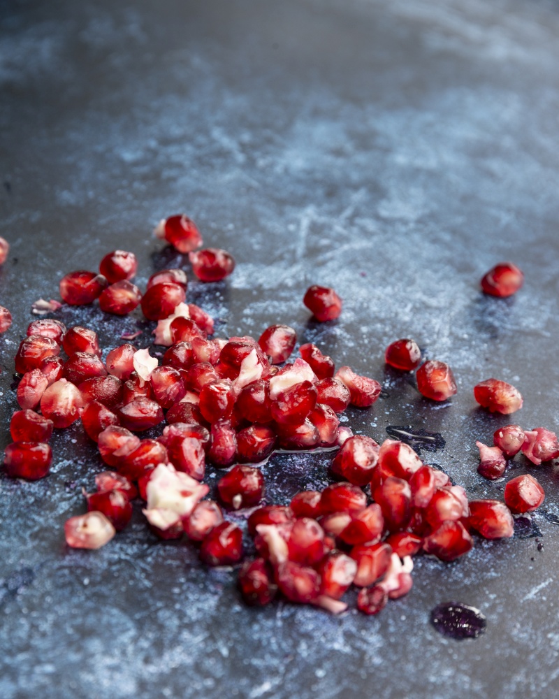 Beautiful food portrait of pulled Pomegranate and seeds with vintage texture background