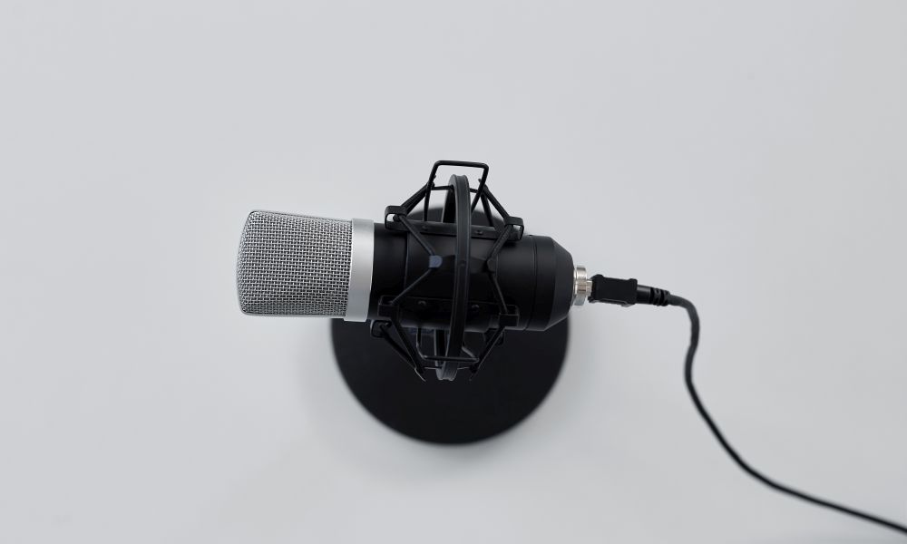 technology and audio equipment concept - close up of microphone on white background. close up of microphone on white background