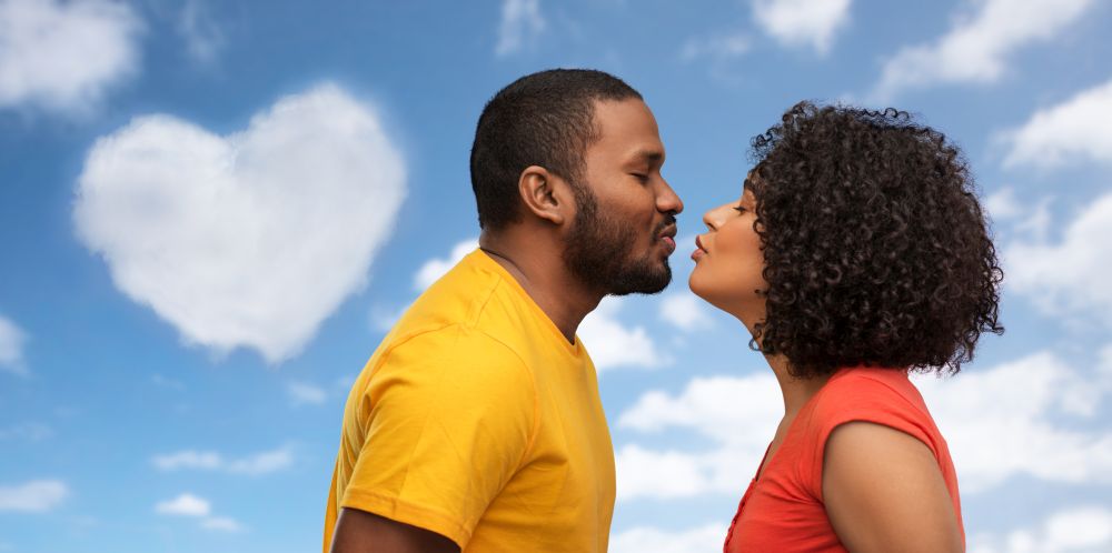 love, relationships and valentines day concept - happy african american couple reaching for kiss over grey background. happy african american couple reaching for kiss