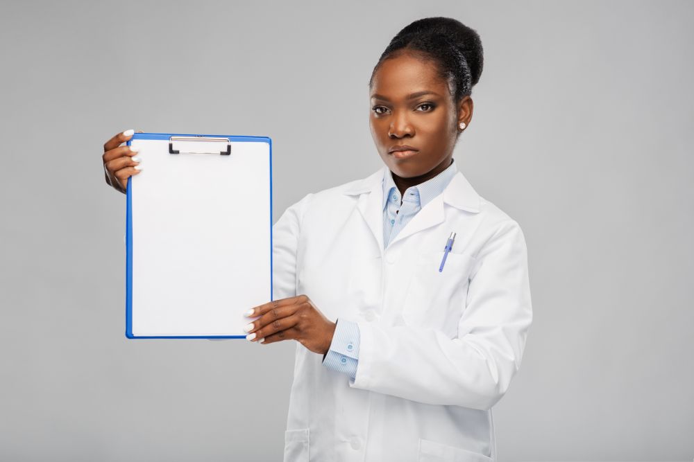 medicine, profession and healthcare concept - african american female doctor or scientist in white coat with clipboard over grey background. african american female doctor with clipboard