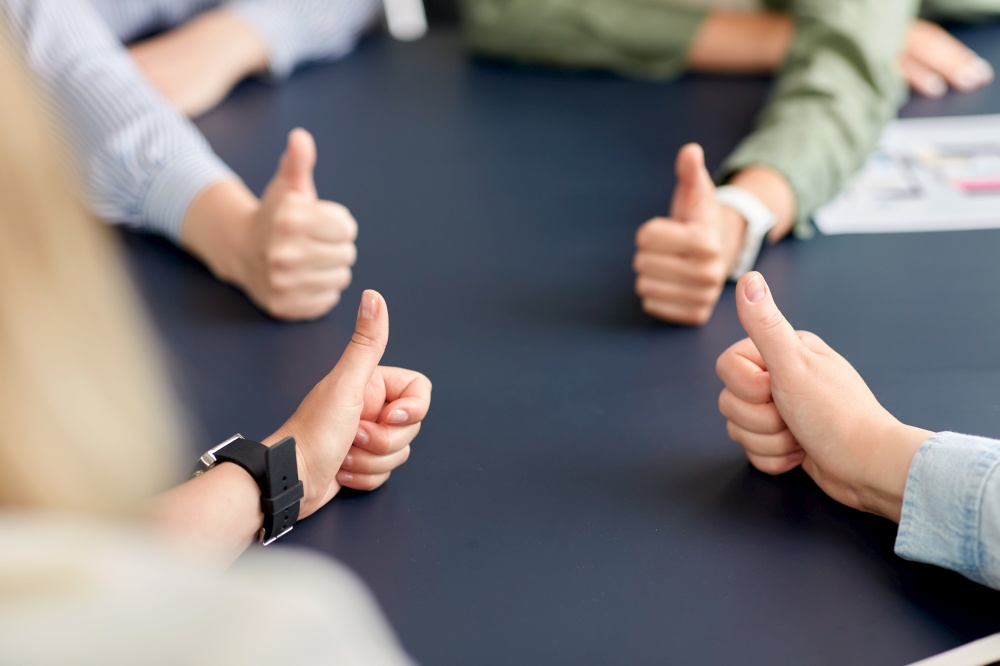 success, business and team work concept - close up of hands showing thumbs up. close up of business team showing thumbs up