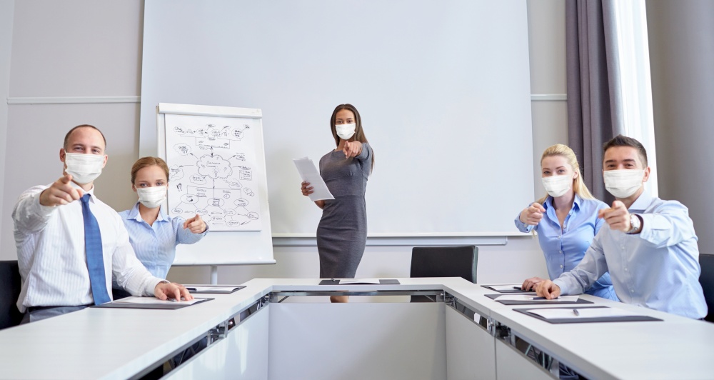 business and pandemic concept - group of people wearing face protective medical mask for protection from virus disease at office meeting pointing finger at you. business people in masks pointing finger at you