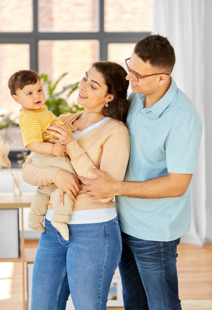 family and people concept - portrait of happy mother, father and baby son at home. happy family with child at home