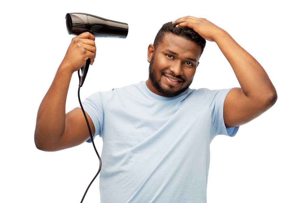 grooming, hairstyling and people concept - smiling young african american man with fan or hair dryer over white background. african american man with fan or hair dryer