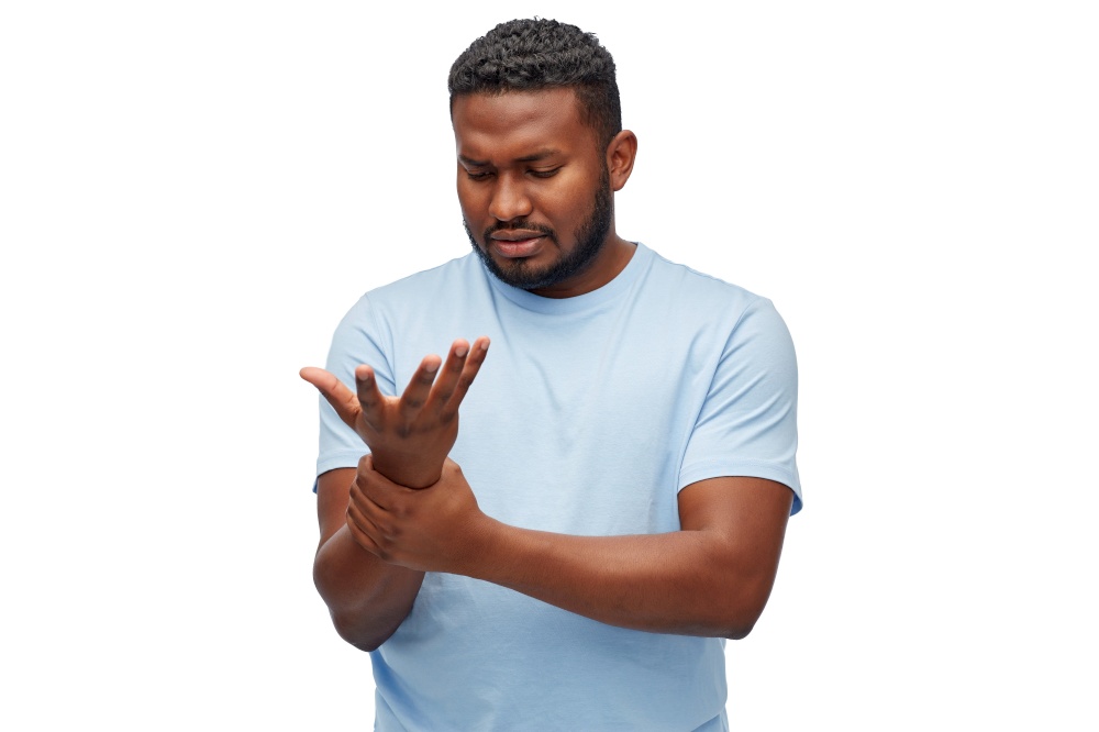 health problem and people concept - unhealthy african american man suffering from pain in hand over white background. african american man suffering from pain in hand