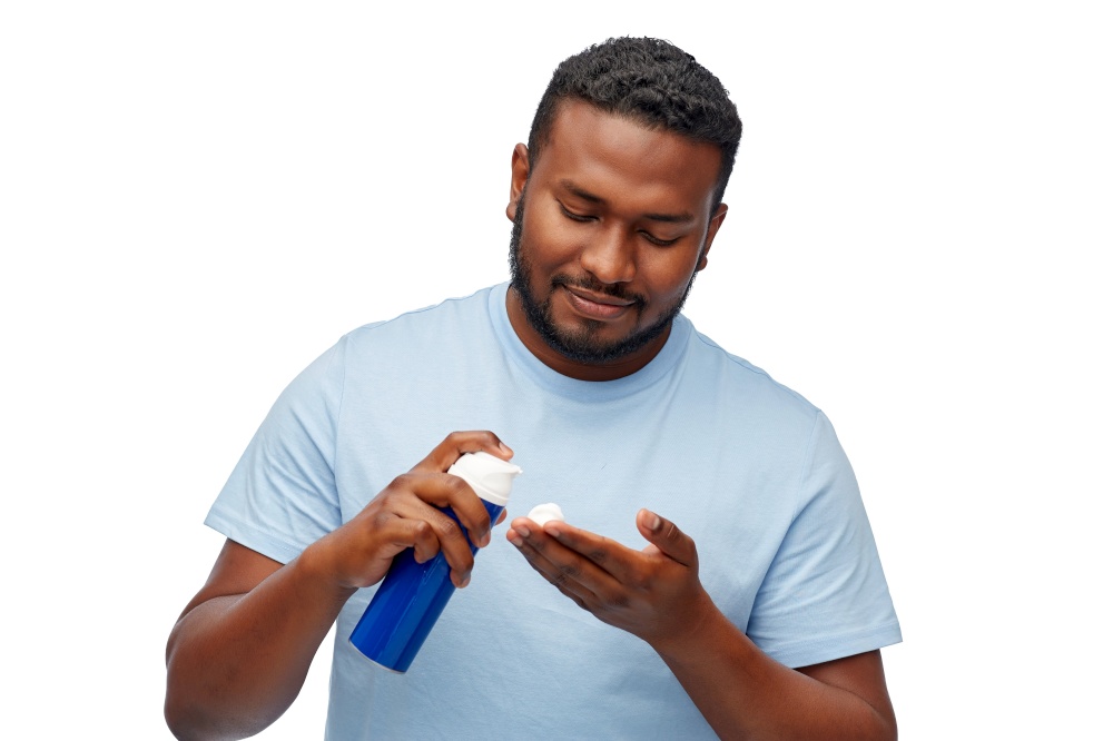 grooming and people concept - happy african american man with shaving cream over white background. happy african american man with shaving cream