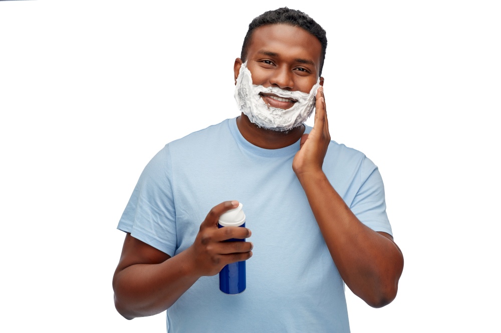 grooming and people concept - african american young man with shaving cream on his beard over white background. african american man with shaving cream on beard