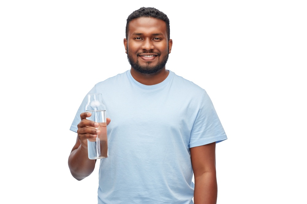 sustainability, consumerism and eco friendly concept - happy smiling african american man with water in reusable glass bottle over white background. happy african man with water in glass bottle