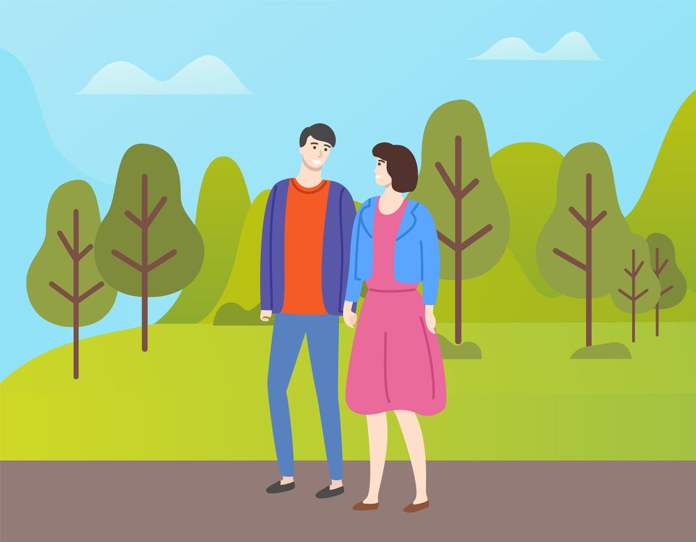 Couple in casual cloth spend time together outdoors. People in love and fall season, man and woman walking in autumn park among yellow and orange trees. Couple in Casual Cloth Spend Time Together Outdoor