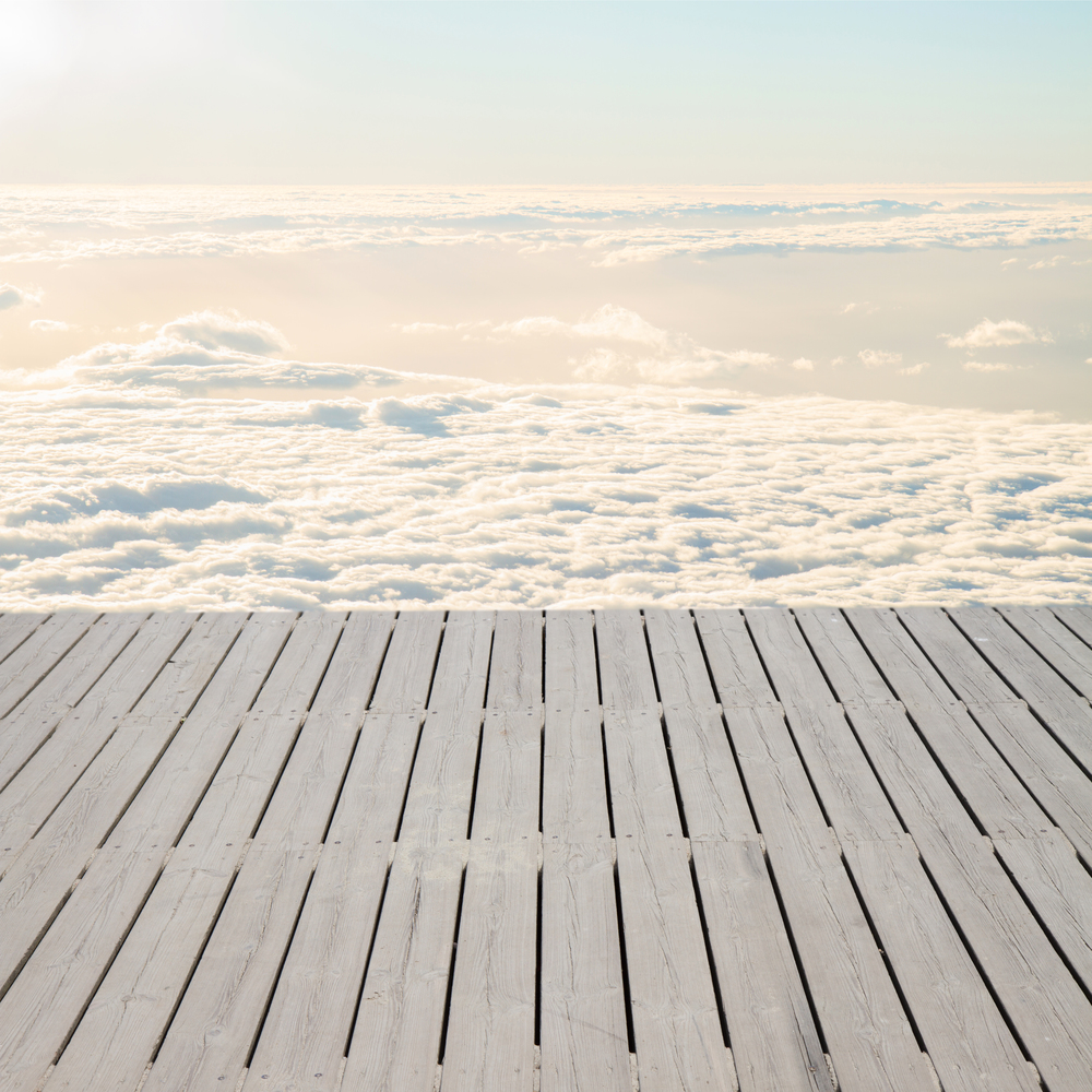 wooden pier over sky with white clouds. pier over clouds