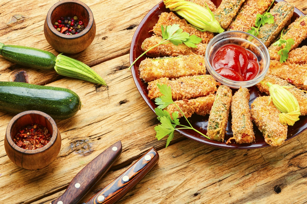 Baked zucchini sticks with sauces,roasted zucchini.Breaded fried zucchini. Zucchini sticks in breadcrumbs
